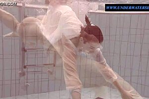 Hey, check out tattooed teen Sara swimming in clothes underwater!