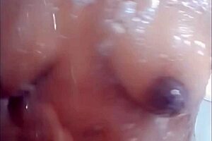 Ebony slave Cyndy Blackslave bathes in shower under master's gaze, exposing tits in homemade BDSM scene