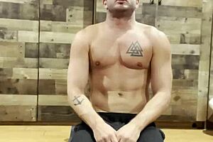 Bodybuilder stretches in a sexy muscular routine