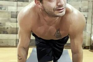 Bodybuilder stretches in a sexy muscular routine