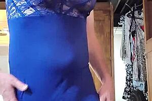 Shemale in blue dress teases cock with big tits.