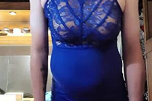 Shemale in blue dress teases cock with big tits.