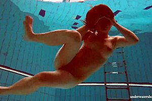 petite russian babe deniska swimming underwater in the pool