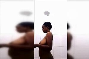 Huge titted black cutie with natural tits and nipples takes a detailed shower.