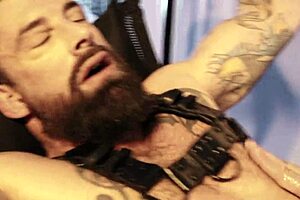 man stretches with machine in leather bondage 😏