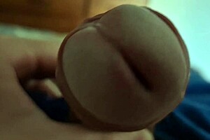 Detailed close-up of a young twink's dick head in solo play.