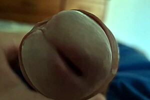 Detailed close-up of a young twink's dick head in solo play.