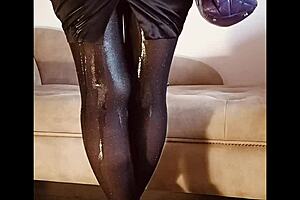 A woman pees in her shiny pantyhose during a free moment.