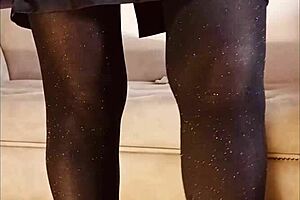 A woman pees in her shiny pantyhose during a free moment.