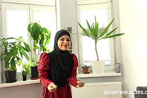 Cute woman in hijab enjoys unexpected fun.
