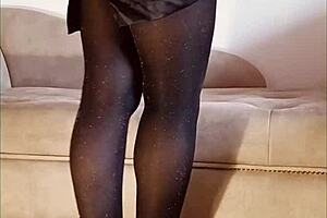 A woman pees in her shiny pantyhose during a free moment.