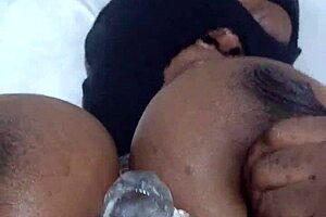 Black beauty enjoys solo pleasure with a dildo.