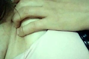 Feeling horny, I touch myself in grandma's living room with small tits exposed.