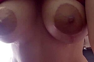 A big-boobed woman gets a sensual massage with oil and then has sex with her husband in the kitchen.