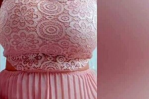 Wow, pretty girl in pink dress plays with her big tits!