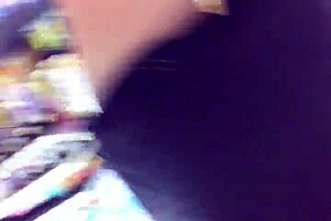 Cute girl paces through the store while spied on hidden cam outdoors.