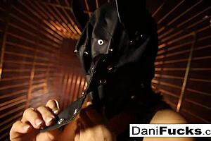 Dani Daniels teases with her big tits while masturbating in a cage.