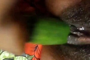 Close up and personal with a black pussy and a cucumber