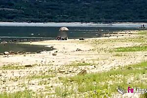 Ebony babe rides guy bent over next to the lake