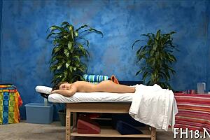 A skilled masseuse gives a sensual massage with oil