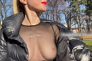 Beautiful woman showing her big boobs in a public park