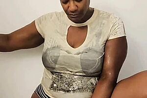 Ebony babe masturbates in shower while fully clothed