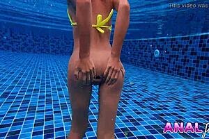 Skinny Thai girl swims in bikini with big butt plug in ass