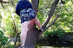 The horny milf masturbates with dildo, legs high, outdoors