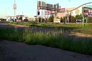 pretty blonde explores public street with friends in outdoor gathering