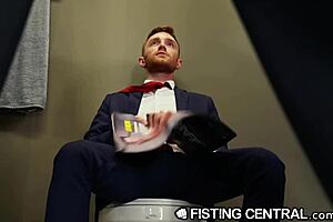 Redhead gets fisted by mature boss in public bathroom