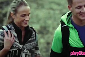 Photographer shoots petite model outdoors in nature.