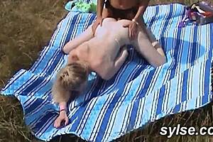 Two amateur women share a quiet moment by the roadside