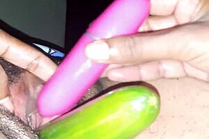 Sexy Indian wife uses vibrator and cucumber on oiled pussy.