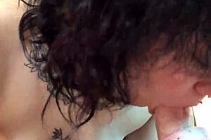 A small tattooed woman gives a blow job in POV style