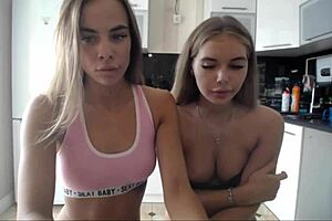 lesbians play a game in the kitchen with tits exposed