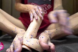 Girl plays with glitters and gives footjob to big dildo - foot fetish