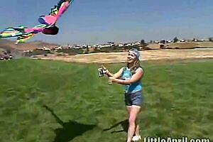 Petite teen masturbates outdoors and sucks a popscicle