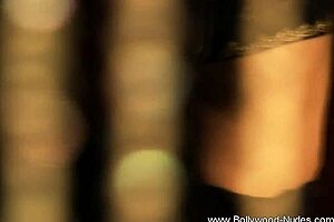 brunette indian woman dances seductively undressing nude teasing with ripped clothes