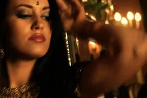 brunette indian woman dances seductively undressing nude teasing with ripped clothes