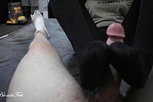 Watch Miley Grey deliver a hot footjob in nylons, teasing with her legs.