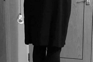A crossdresser in self-bondage in a uniform