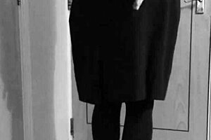 A crossdresser in self-bondage in a uniform