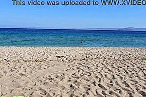 Young European nudist enjoying public beach in a natural way