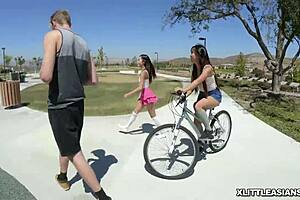 Two Asian cuties share a white cock orally