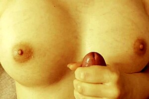 Cutie massages her slippery tits while jerking off in a casual scene.