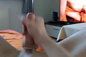 Skinny German guy masturbates and cums while watching gay porn