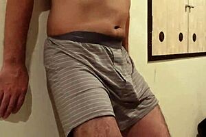 A woman uses my cock and balls as a sandbag and a man beats me, why do I still get an erection?