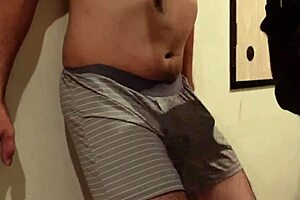 A woman uses my cock and balls as a sandbag and a man beats me, why do I still get an erection?