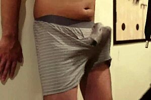 A woman uses my cock and balls as a sandbag and a man beats me, why do I still get an erection?