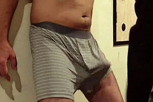 A woman uses my cock and balls as a sandbag and a man beats me, why do I still get an erection?